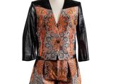 an orange and black jacket and shorts are on a mannequin mannequin mannequin mannequin mannequin mannequin mannequin mann