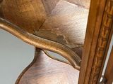 a wooden chair that has a wooden seat on top of it