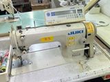 an image of a sewing machine in a factory
