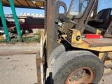 a forklift that is parked next to a building