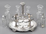 a silver plate with a silver tray and glass bottles on it