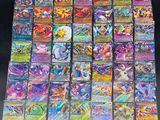 a pile of pokemon cards sitting on top of a table