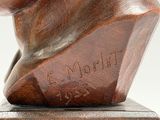 bronze bust of a man on a wooden base with a name engraved on it