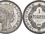 a silver coin with a woman ' s head and a crown on it