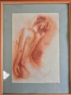 painting of a nude woman in a wooden frame on a wall