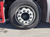a truck that has a flat tire on the side of the road