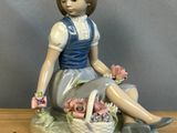 une figurine représentant une fillette assise sur une table