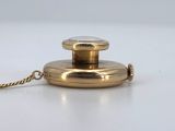 an image of a gold colored pocket watch with a chain on a white surface