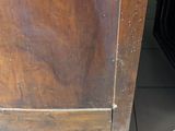 a wooden cabinet with a drawer on top of it