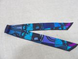 purple, blue and black neck tie with a picture of a man on a bike