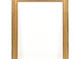 a gold picture frame on a white wall with a white background