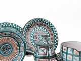 several pieces of blue and white pottery sitting on top of a table