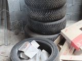 a pile of tires sitting on the ground next to a pile of boxes