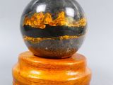 an image of a marble ball sitting on top of a wooden stand