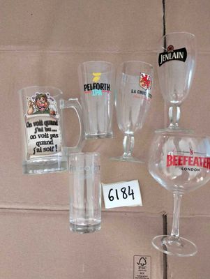 many glasses and cups that are on display on a shelf