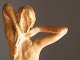 statue of a woman holding her hands behind her head