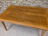 an image of a wooden table with a brick wall in the background
