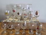 a lot of wine glasses sitting on a wooden table