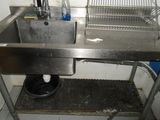 a stainless steel sink in a small room