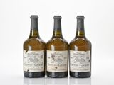 three bottles of wine sitting next to each other on a white surface