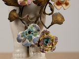 a white vase with a bunch of flowers in it