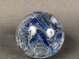 a blue and white marble ball on a table
