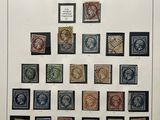 an old picture of a collection of stamps on display in a glass case