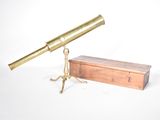 un télescope ancien en laiton, avec son coffret en bois et son socle, sur fond blanc
