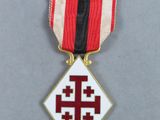 a close up of a medal with a cross on it
