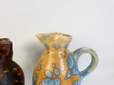 two vases sitting next to each other on a table