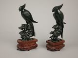pair of chinese carved jade parrots on a branch