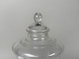 a clear glass jar with a lid on a table