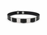 a close up of a black and white bracelet on a white background