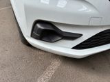 the front end of a white car with a black bumper