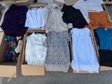 a lot of clothes in a box on the ground