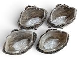 four oysters with shells in them on a white surface