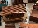 a lot of small wooden buildings that are on a table