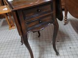 a small table with a picture on it in a room