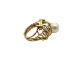 a close up of a gold ring with a pearl on it