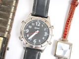 a silver watch and a black watch on a white surface
