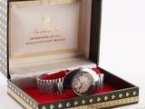 a watch that is in a box with a red cloth