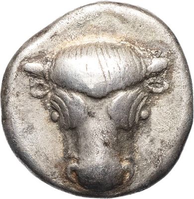 a close up of a silver coin with a bull head on it