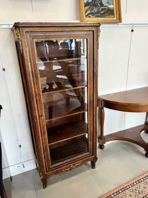 a small table and a cabinet in the corner of a room