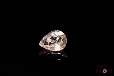 a close up of a white diamond on a black surface
