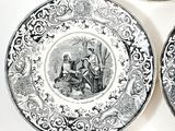 three black and white plates with a picture of a man and a woman on them