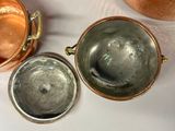 three pots that are sitting on a table next to each other