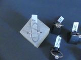 three rings and a ring holder on a table