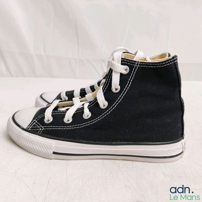 a close up of a pair of black converse shoes