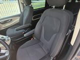 two seats in the back of a van with a steering wheel