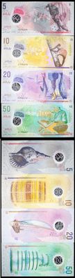 four different bills of different colors and designs on a black background